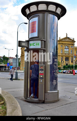 Coin operated public toilet on pavement of city street downtown Prague, Czech Republic Stock Photo