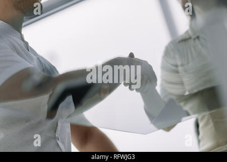 bottom view. handshake of business people on a work Desk Stock Photo