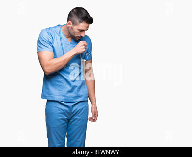 Handsome young doctor surgeon man over isolated background feeling unwell and coughing as symptom for cold or bronchitis. Healthcare concept. Stock Photo
