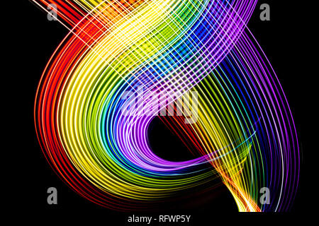 Rainbow of light. Photography made with light painting. Abstract lines with the colors of the rainbow on black background. Resource for designers. Stock Photo