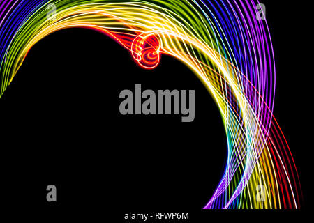 Rainbow of light. Photography made with light painting. Abstract lines with the colors of the rainbow on black background. Resource for designers. Stock Photo