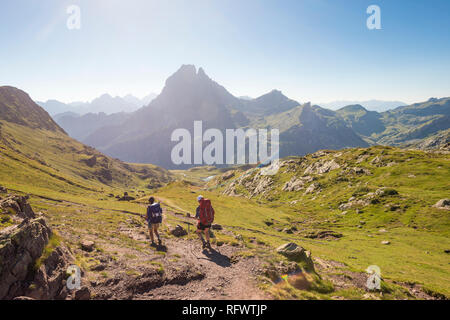 Walkers descend from the top of Col d'Ayous on the GR10 trekking route in the French Pyrenees, Pyrenees Atlantiques, France, Europe Stock Photo