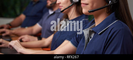 People in call center talking with people on headphones Stock Photo