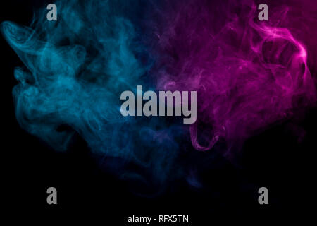 Dense multicolored smoke of   pink and blue colors on a black isolated background. Background of smoke vape Stock Photo