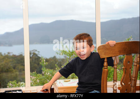 Young boy in a room with an ocean view Stock Photo