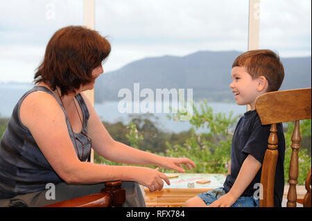 Mother and son playing Monopoly Stock Photo