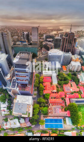 Aerial view over roof tops of tall modern urban high-rise towers around North Sydney post office 2060 from ground level to sky and distant Sydney Harb Stock Photo