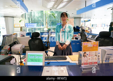 INCHEON, SOUTH KOREA - CIRCA MAY, 2017: indoor portrait of woman at travel center in Incheon International Airport. Stock Photo