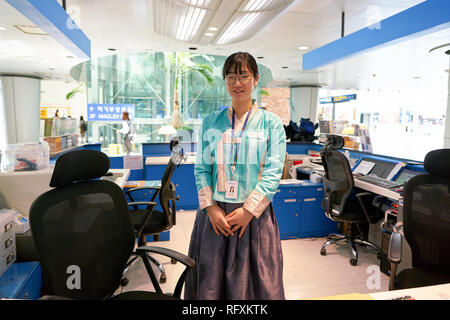 INCHEON, SOUTH KOREA - CIRCA MAY, 2017: indoor portrait of woman at travel center in Incheon International Airport. Stock Photo