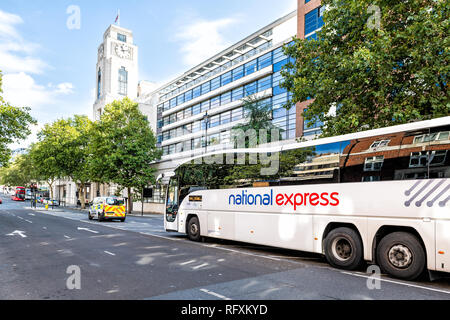 London, UK - September 15, 2018: National Express shuttle bus parked white sign text transport service on street road by Victoria Coach Station exteri Stock Photo