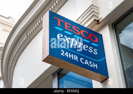 London, UK - September 16, 2018: Neighborhood local store Tesco Express grocery shopping facade exterior entrance with closeup of sign and 24 hour cas Stock Photo