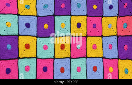 Beautiful handmade multi-colored knitted plaid as a background or backdrop Stock Photo