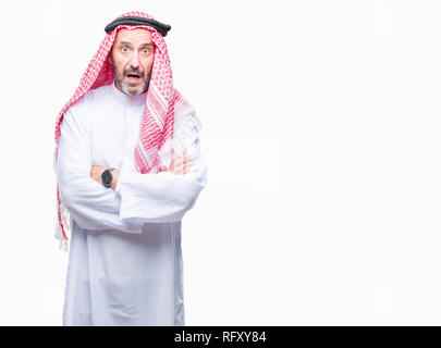 Senior arab man wearing keffiyeh over isolated background afraid and shocked with surprise expression, fear and excited face. Stock Photo