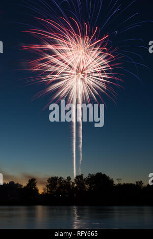 Assorted colored fireworks over the Illinois River on 4th of July.  Ottawa, Illinois, USA Stock Photo