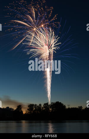 Assorted colored fireworks over the Illinois River on 4th of July.  Ottawa, Illinois, USA Stock Photo