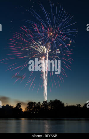 Assorted colored fireworks over the Illinois River on 4th of July.  Ottawa, Illinois, USA Stock Photo