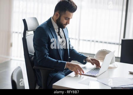 Portrait of a nice handsome man with beard working in the office Stock Photo