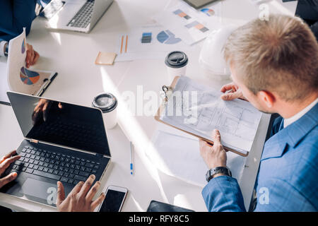 Business people meeting with charts and graphs, use laptop, close up, top view. Stock Photo