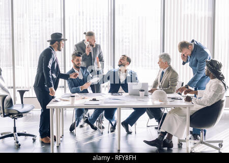 Serious male colleagues constructors checking sketch working in team cooperate Stock Photo