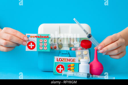 Flat lay composition with first aid kit on blue background. Stock Photo