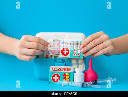 Flat lay composition with first aid kit on blue background. Stock Photo