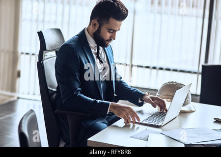 Elegant businessman working with laptop. Stock Photo