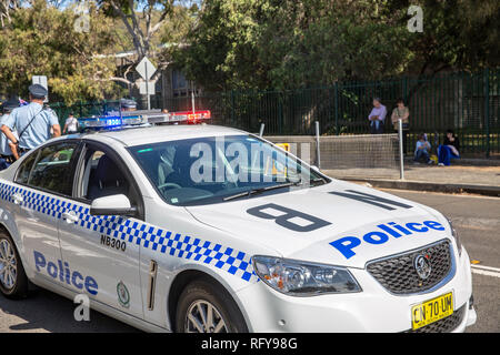 New South Wales police force car, Holden Commodore police vehicle in Sydney,Australia, with policeman at car rear Stock Photo