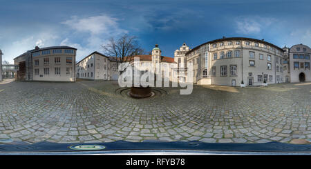 360 degree panoramic view of Three-dimensional panorama of Gifhorn Castle, taken from the courtyard in a spherical shape, with a fountain and a defoliated tree in the foreground.