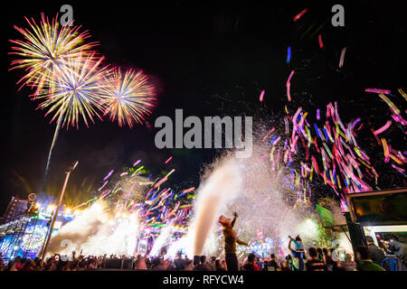 Crowd watching balloons ,fireworks and celebrating new year eve. Multicolored balloons and confetti in the city countdown  festival. Motion blur photo Stock Photo