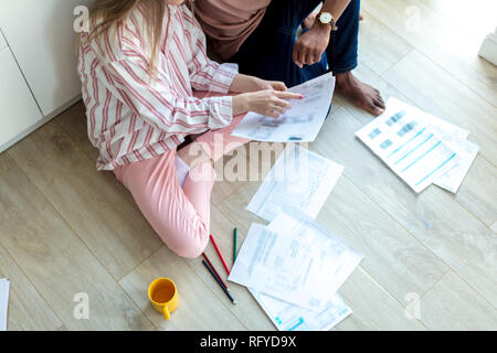 Interracial young couple of entepreneurs sharing idea about new business project Stock Photo