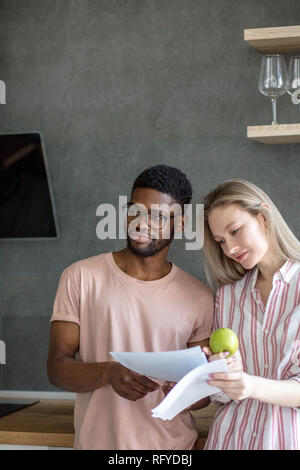 Family of young architects working on a project together at home office. Stock Photo