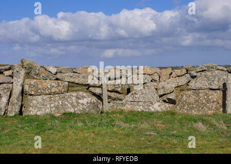 Large Granite boulders create a long lasting dry stone wall.The wall is Lichen and moss covered large stones with holes.Cornwall;UK;England Stock Photo