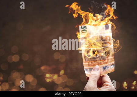 50 Euro bill burning with a bright flame Stock Photo