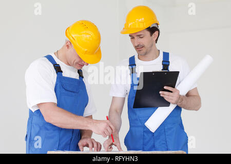 Workers discuss renovation project using digital tablet Stock Photo