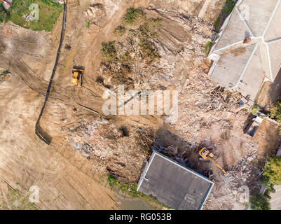aerial top view of demolition site with heavy construction machinery clearing out redevelopment area Stock Photo