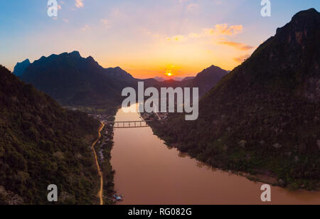 Aerial panoramic Nam Ou River Nong Khiaw Muang Ngoi Laos, sunset dramatic sky, scenic mountain landscape, famous travel destination in South East Asia Stock Photo