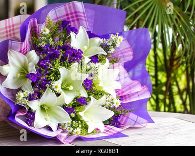 Bouquet of flowers consists of lilies and forget me nots Stock Photo
