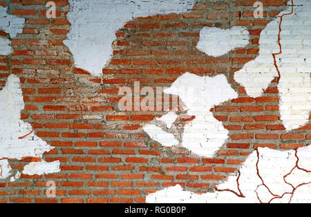 White paint peeling off aging terracotta brick wall, Texture background Stock Photo