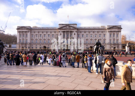 London, England - January 23, 2019. Crowds gather on the grounds and at the gates of Buckingham Palace to watch the daily Changing of the Guard.