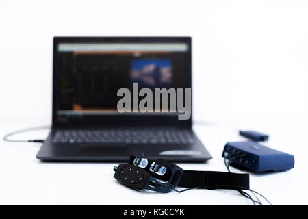 EEG neurofeedback headset and computer. Electroencephalography concept on white background. Stock Photo