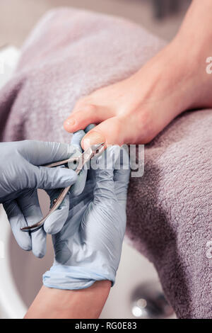 Close up of nail clippers being in use Stock Photo
