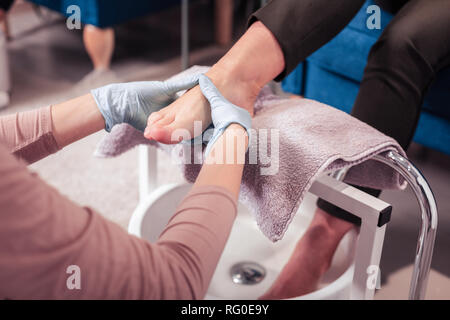 Nice skilled woman doing a foot massage Stock Photo