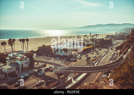 Sunset in Santa Monica, view on beach, pacific ocean and highway, soft focus and low contrast due to rimlight, monochrome vintage toned Stock Photo