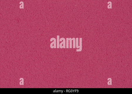 Dark pink foam EVA texture with granular surface for your unique project. Stock Photo