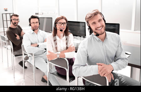 smiling operators support in the workplace Stock Photo