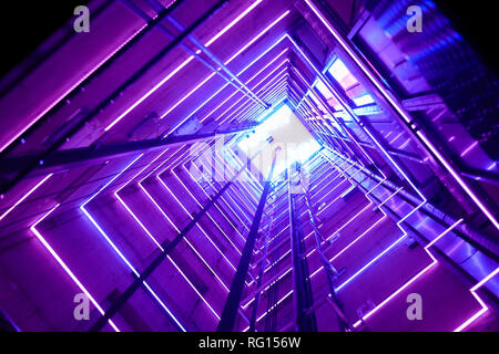 Colorful illumination in a glass elevator Stock Photo