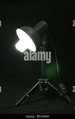 black photography table lamp with photo bulb on black background isolated Stock Photo