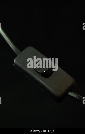black table lamp switch on black background isolated Stock Photo