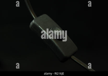 black table lamp switch on black background isolated Stock Photo