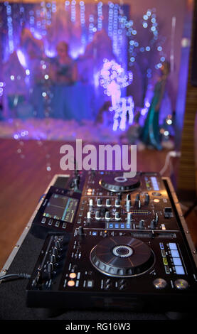 Dj playing disco house progressive electro music at the concert. DJ hands on equipment . DJ plays mix on controller at a disco in the nightclub Stock Photo